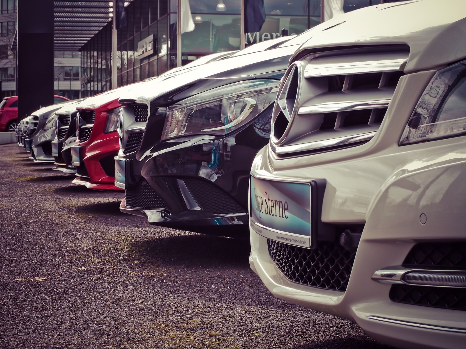Row of new EVs on a dealer lot with window price stickers
