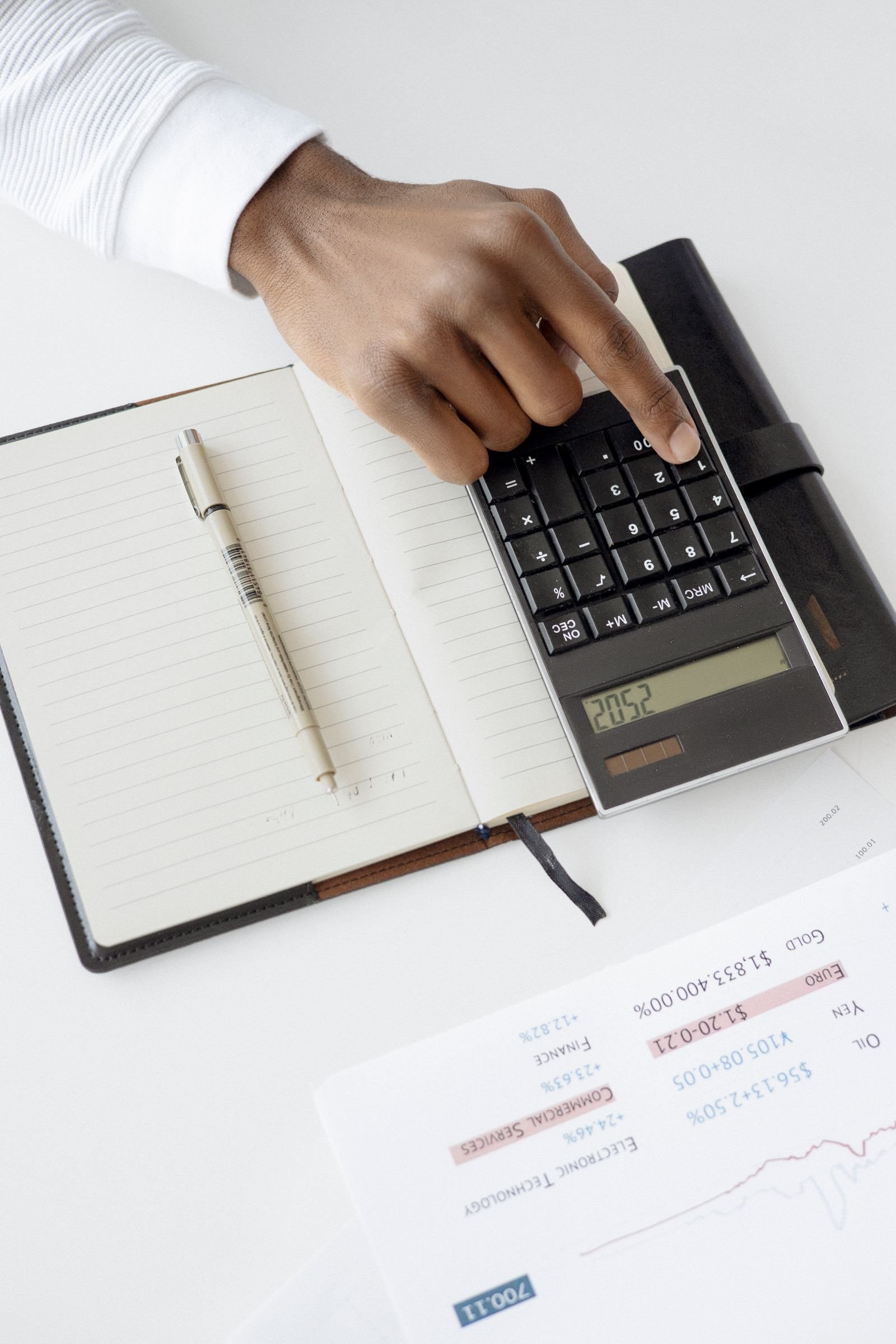 Person working out EV cost of ownership on a spreadsheet with fuel and maintenance columns