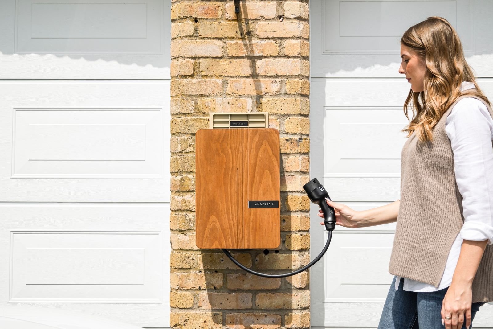 EV plugged into a standard 120V household outlet in a home garage