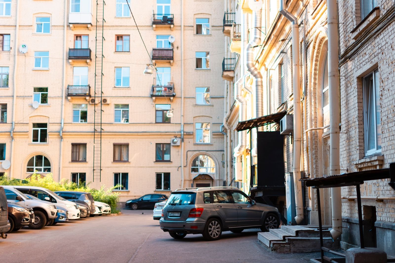 Apartment parking lot with an EV charging map showing nearby stations on a phone