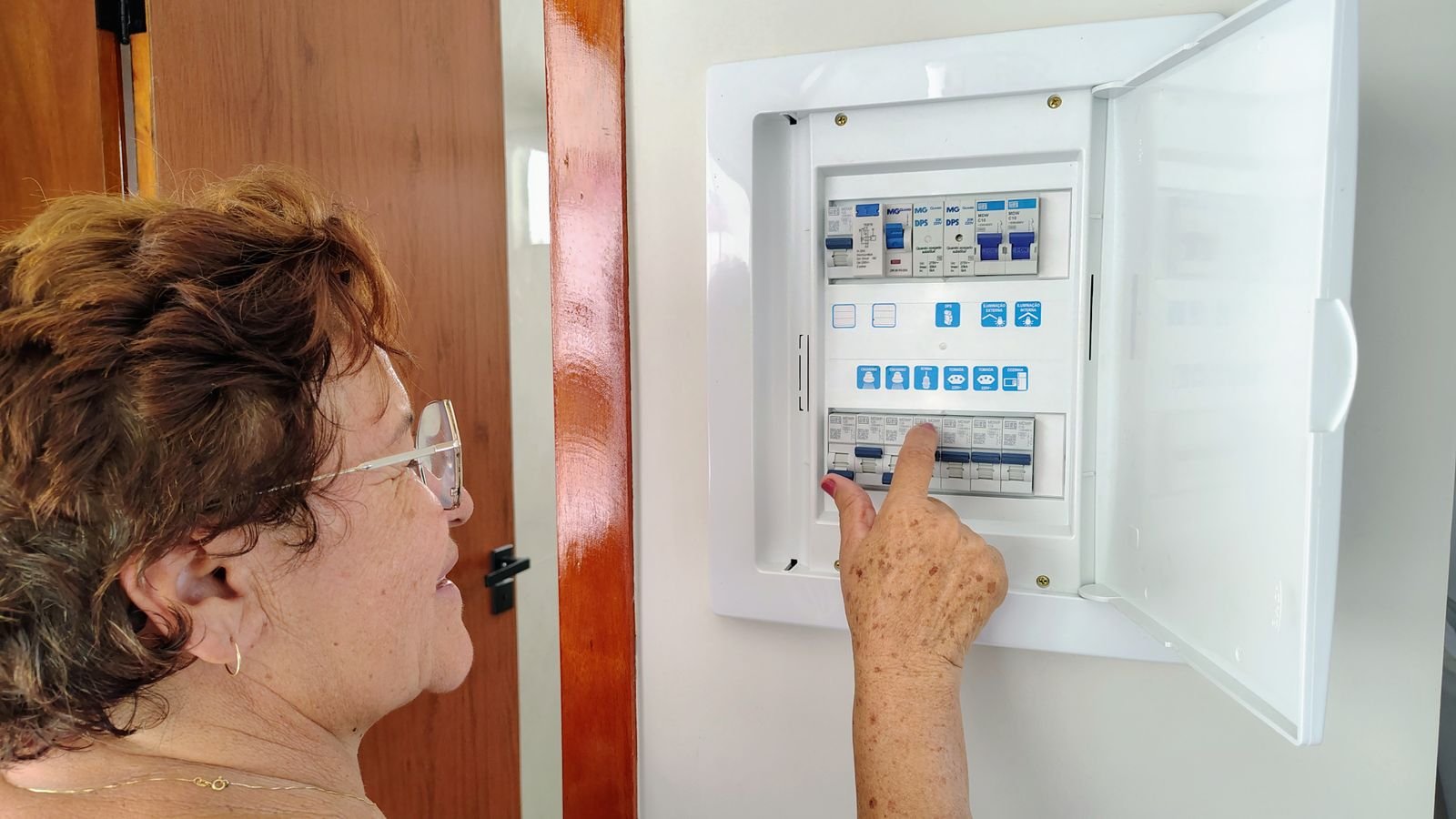 Open home electrical panel with a 240-volt breaker feeding a NEMA 14-50 outlet