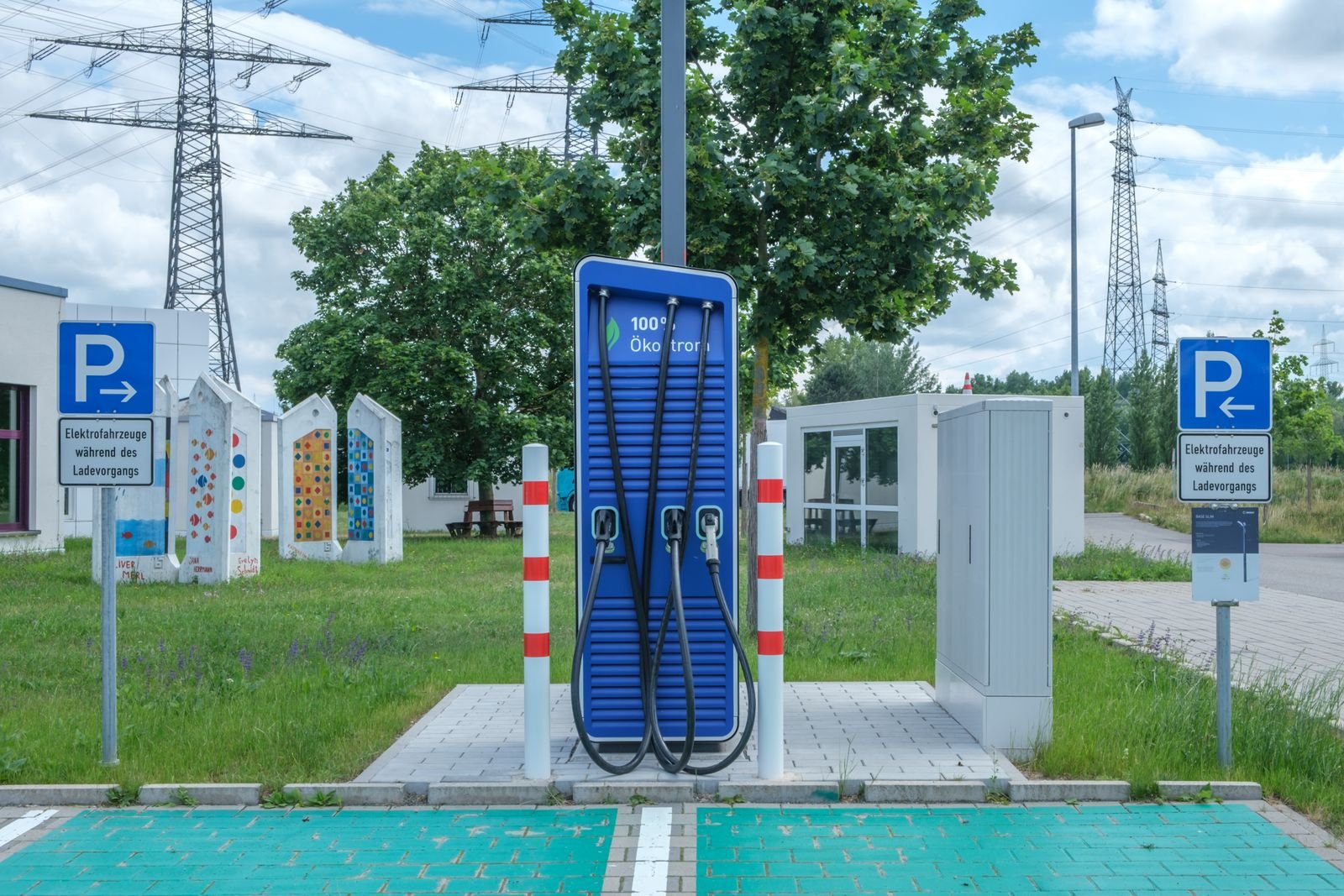 Bank of DC fast-charging stalls at a highway EV charging station
