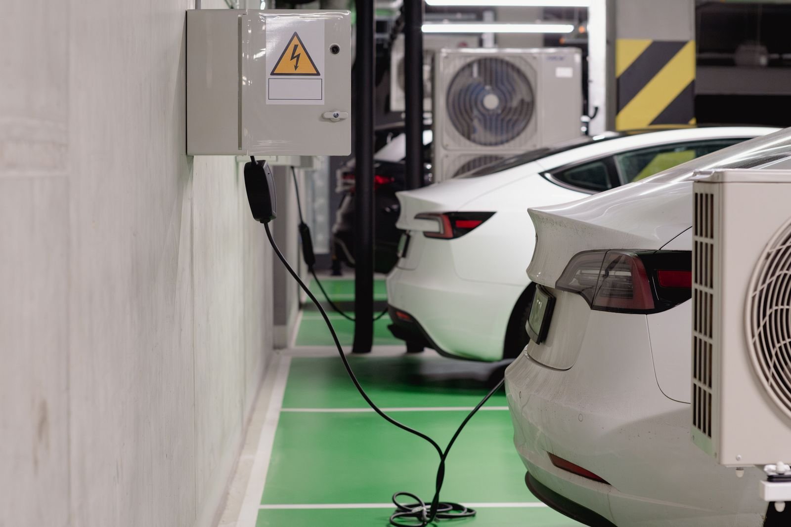 EV plugged in and charging in a condo community parking area