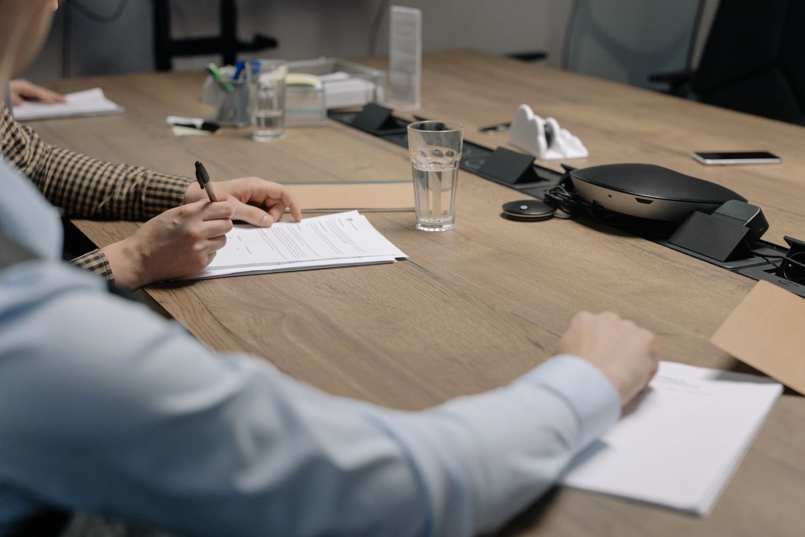 Stack of HOA CC&R documents on a table before a board meeting