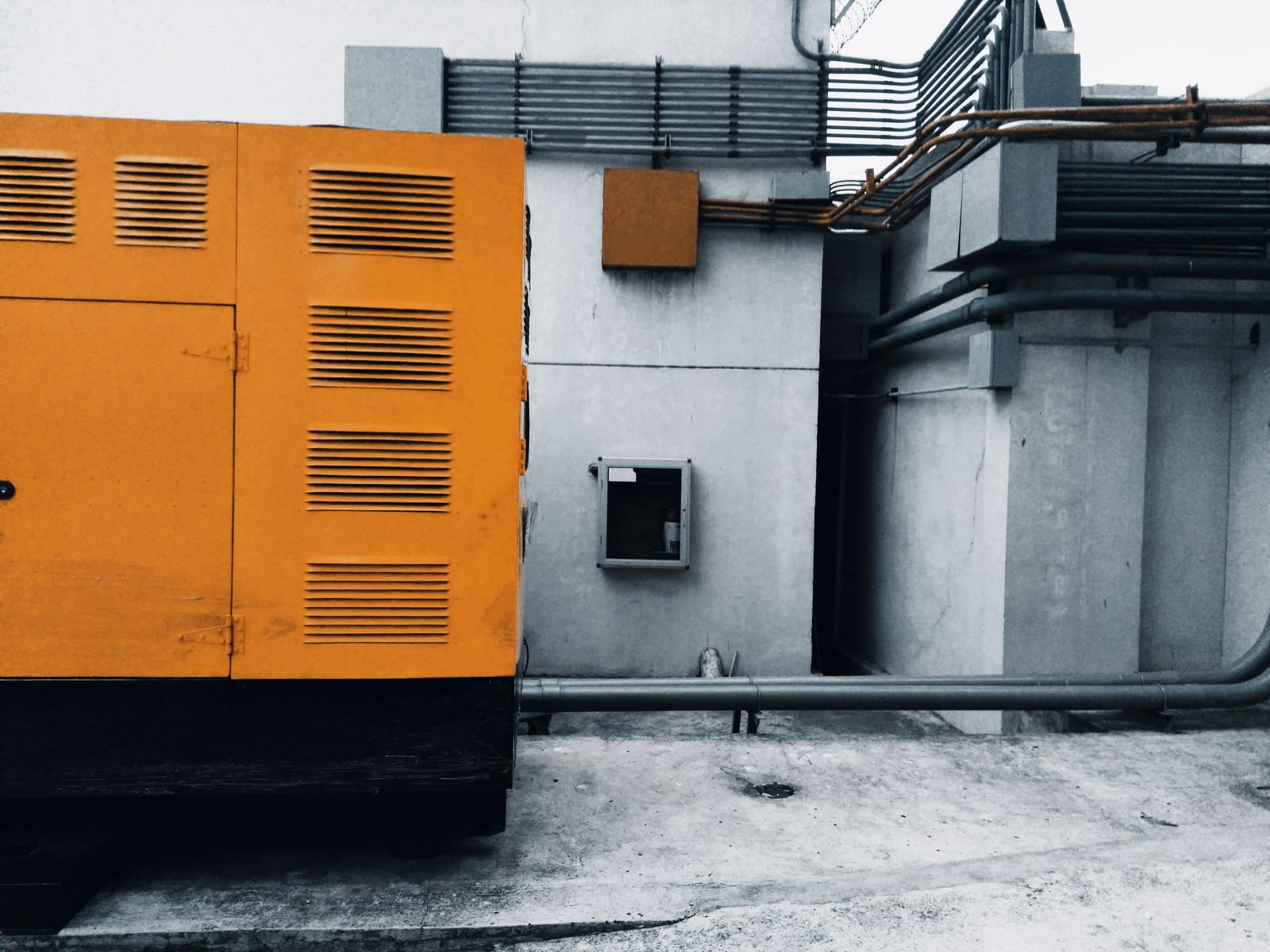 Home standby generator installed on a concrete pad beside a suburban house