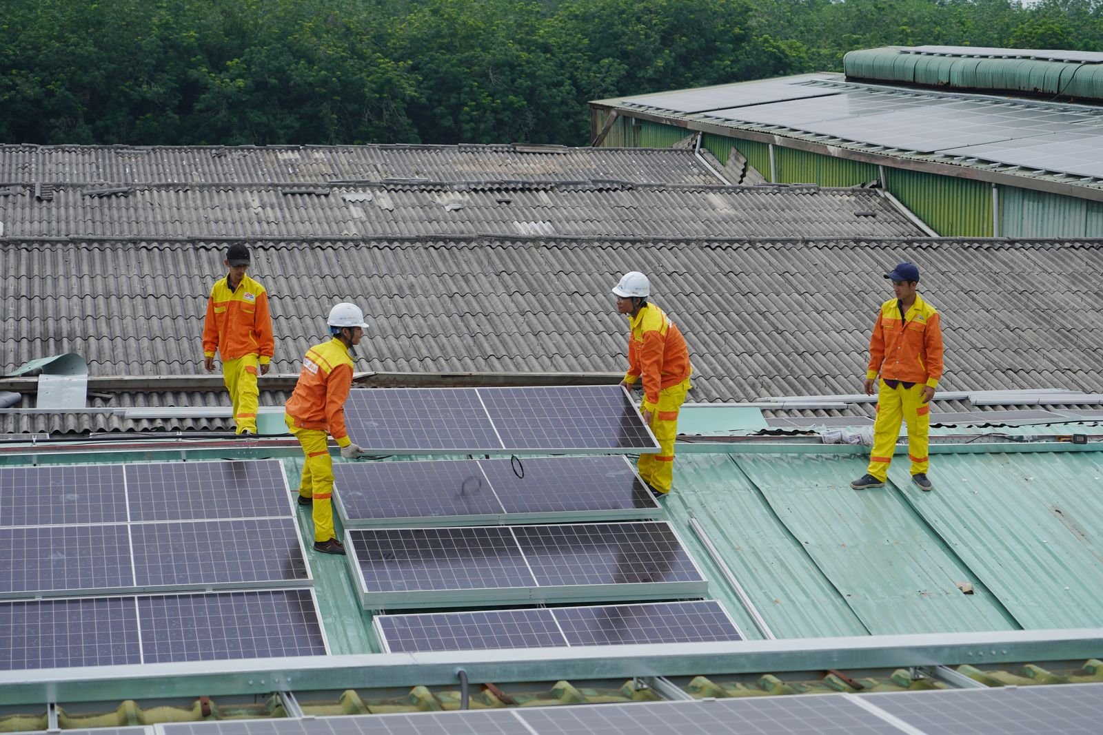 Rooftop solar panel installation in progress with installers mounting panels