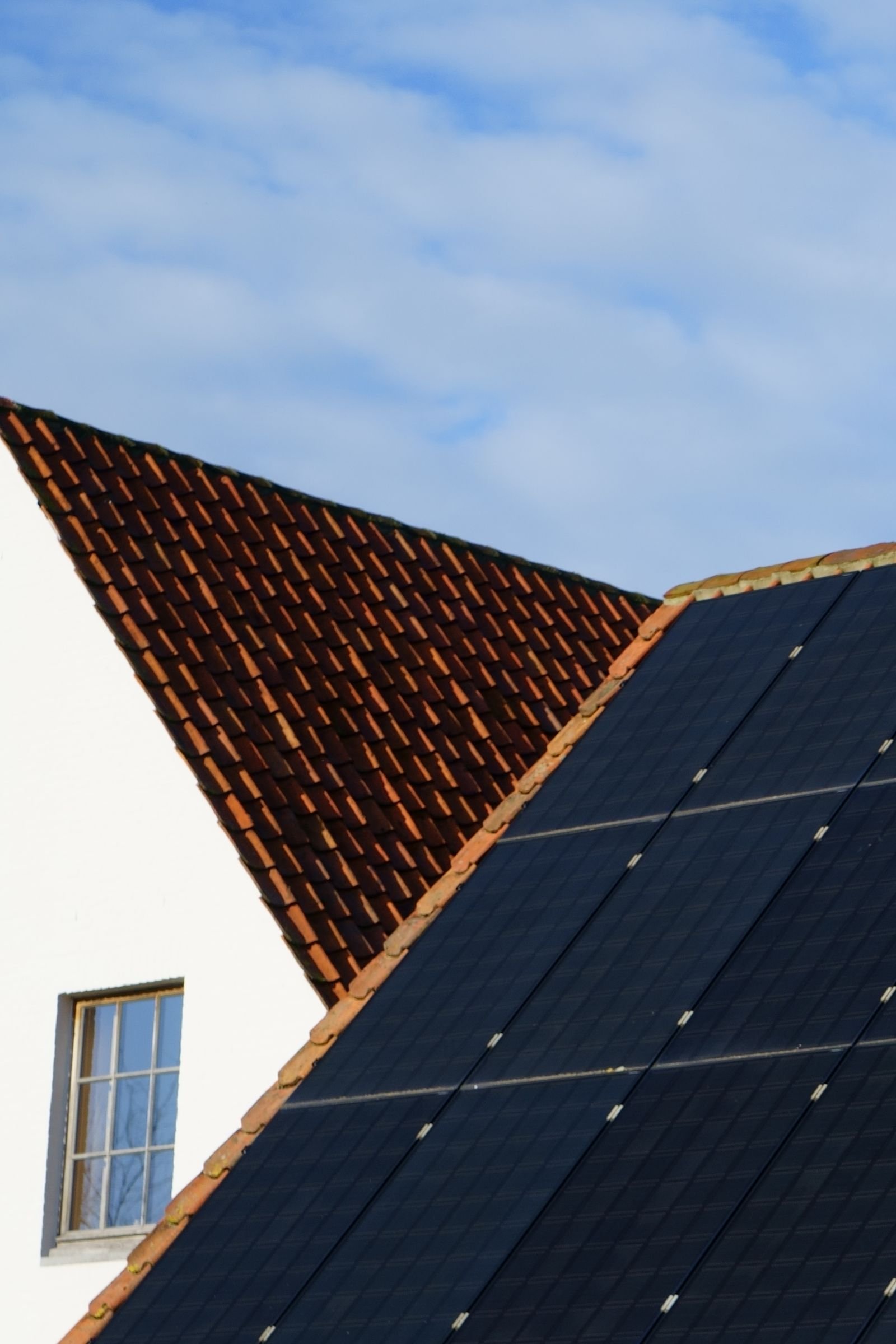 Rooftop solar panels above a closed-for-business storefront sign